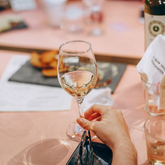 person-holding-wine-glass-near-clear-shot-glasses-696215 person-holding-wine-glass-near-clear-shot-glasses-696215